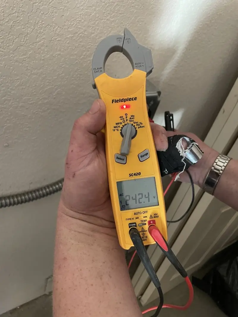 Voltage testing with clamp meter during Whole House Surge Protector in Gulf Hills